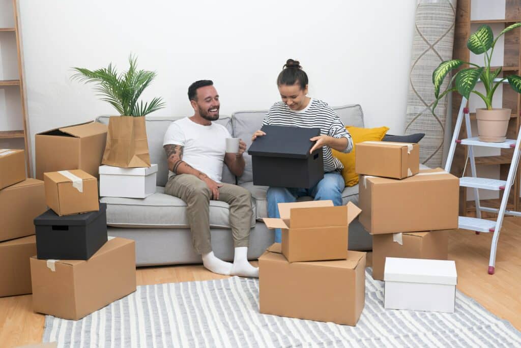 Young woman with lovely husband relaxes celebrating moving