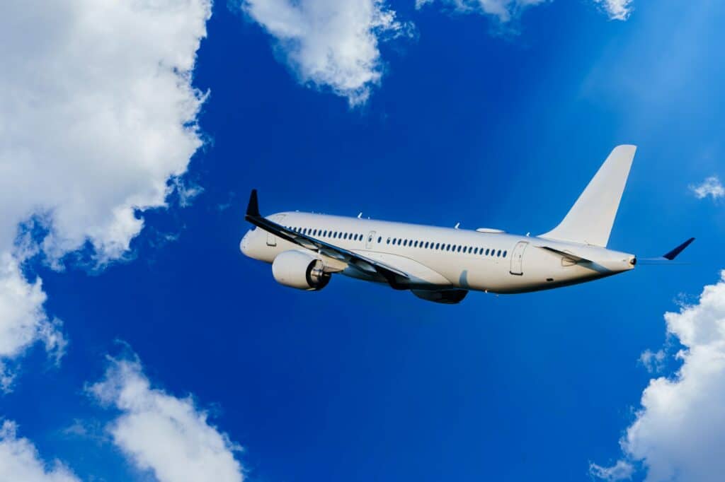 Passengers Commercial airplane flying above dramatic clouds. Travel concept.